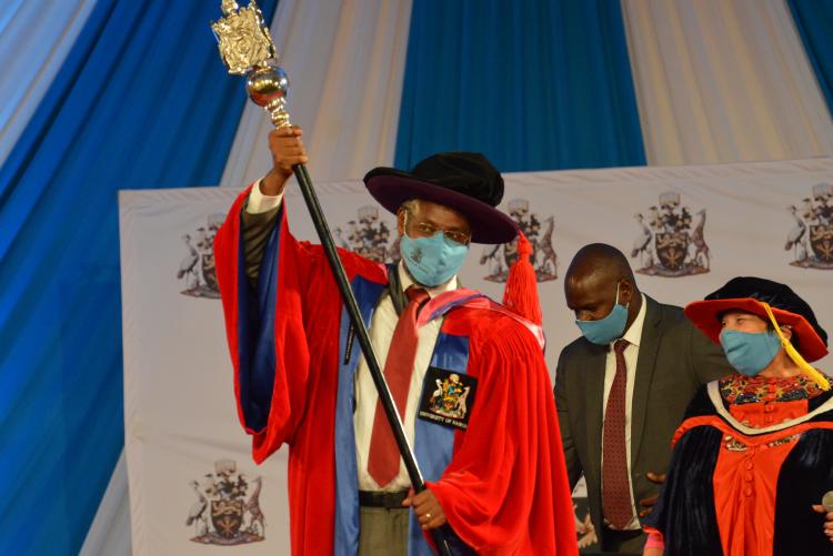 Prof Kiama holding mace of power