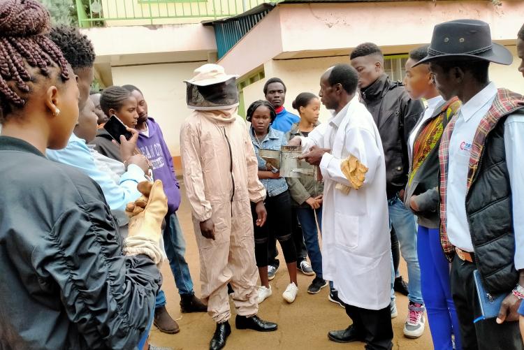 Students demonstration on right attire for honey harvesting or hive inspection