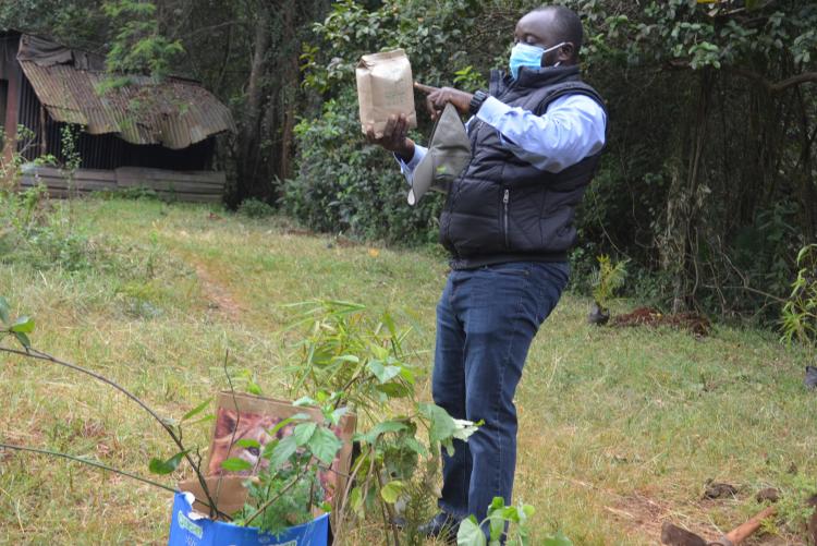  Dr Wasonga  checking  list of species to be planted
